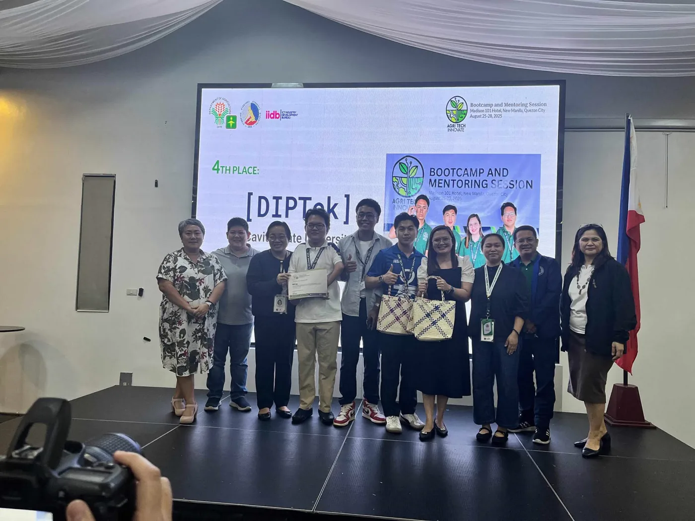 Team DIPTek on stage receiving fourth place at the Agri Tech Innovate Bootcamp, Madison 101 Hotel