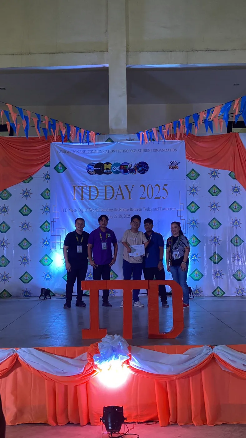 Daniel holding a certificate on stage at ITD Day 2025 with faculty